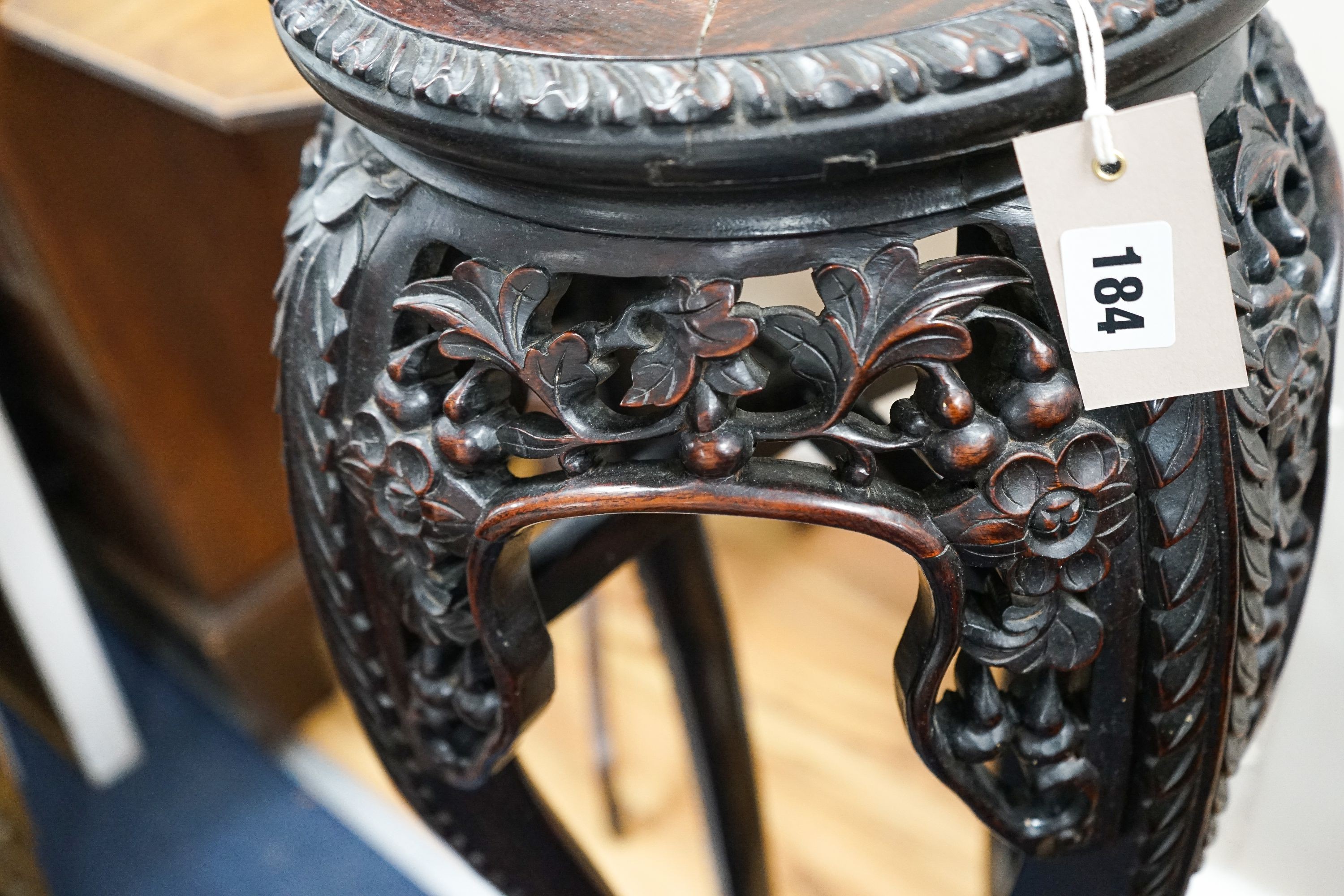 A Chinese circular marble top carved padouk jardiniere stand, height 91cm